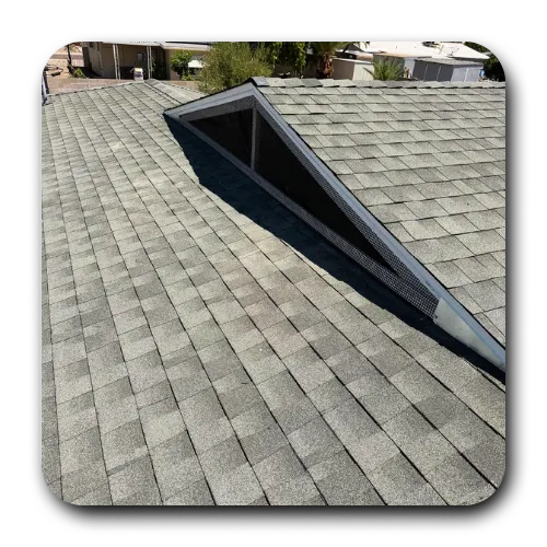 Clean shingle roofing Mesa AZ replacement featuring a triangular roof vent for proper attic ventilation.