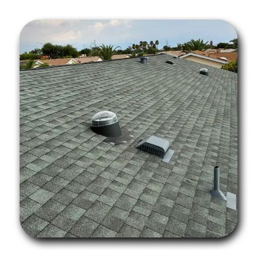 Cleanly installed grey architectural shingle roofing featuring a dome skylight and roof vents by roofers near me.