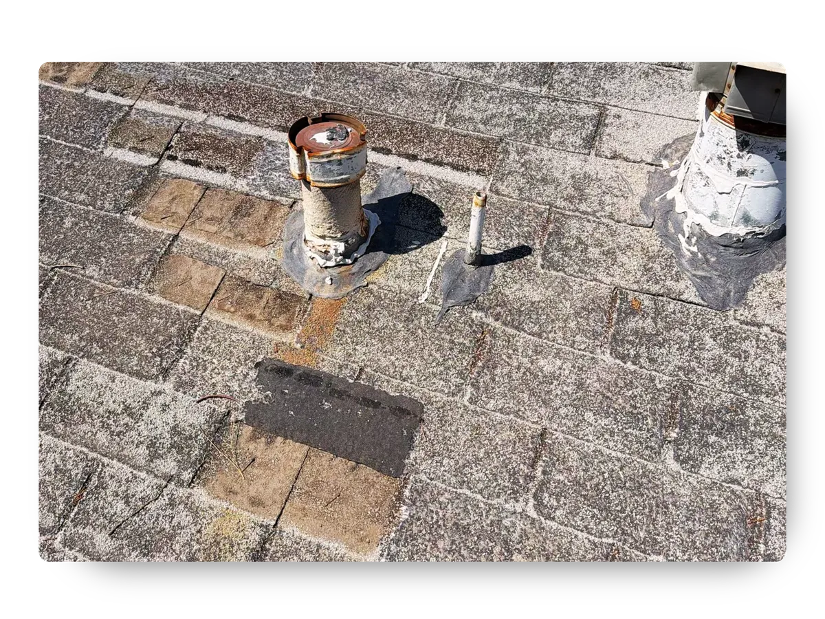 Weather-worn and discolored asphalt shingles with rusted pipe flashing needing roof repair Chandler AZ.