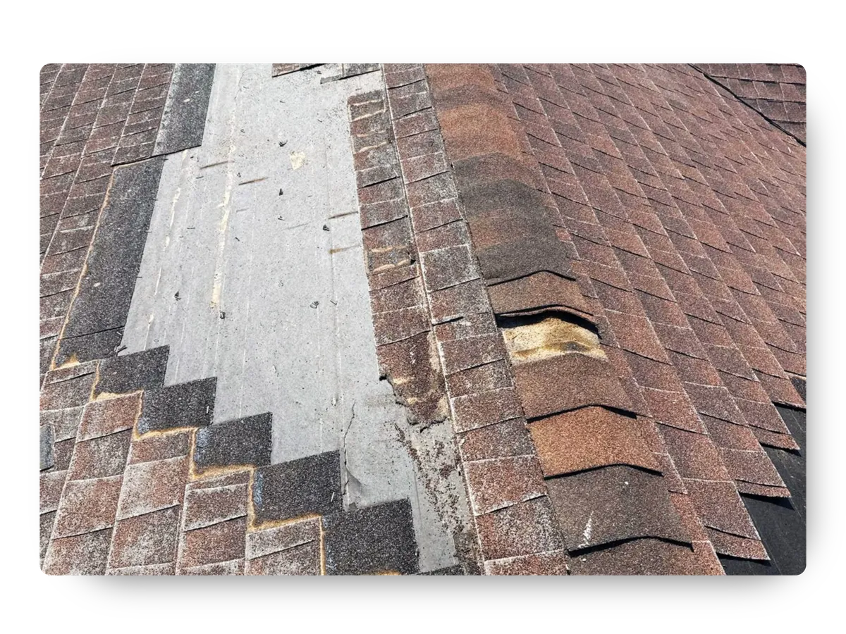 Severely damaged asphalt shingles and exposed underlayment requiring immediate roof repair Apache Junction AZ.