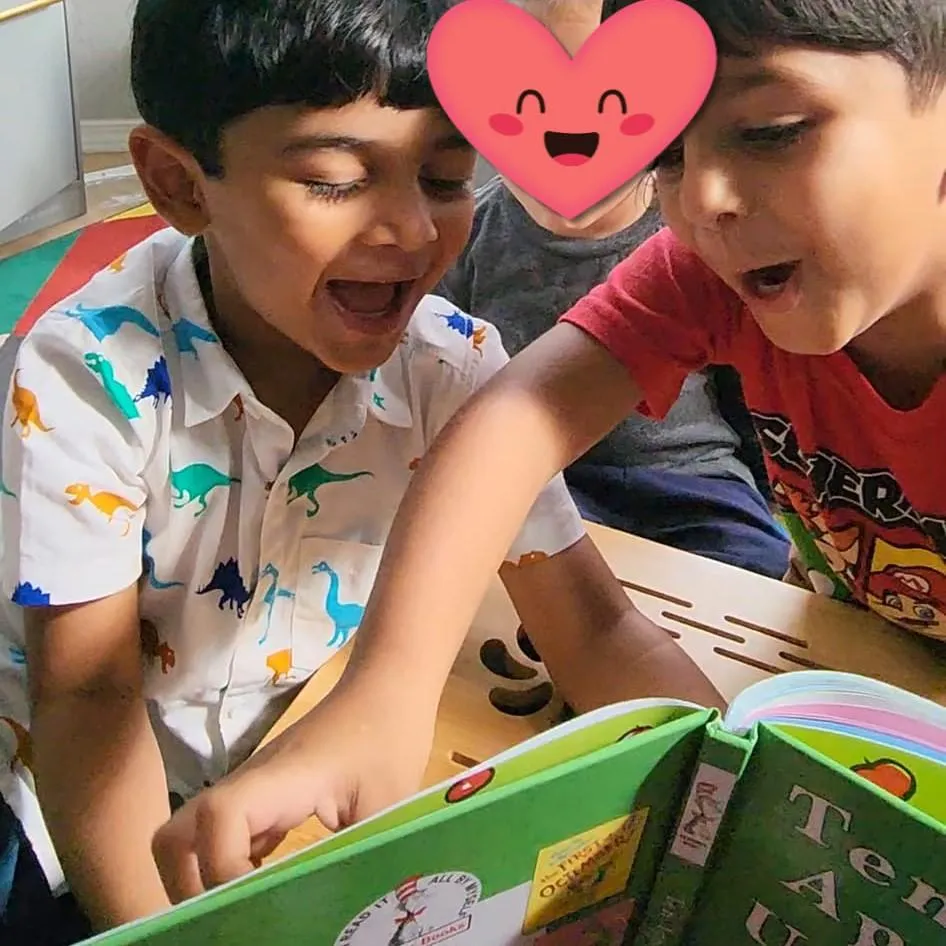 Boy picks paper out of different colored liquids