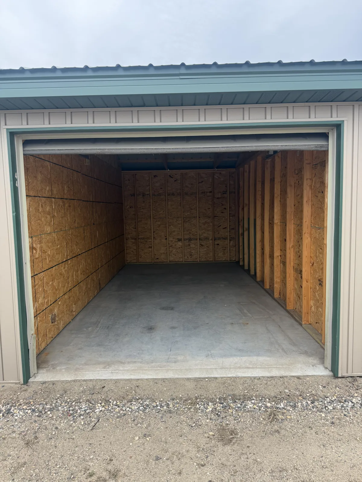 People cleaning trash from a riverbank with a blue bag.