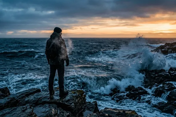 Navy SEAL trainee standing in freezing surf at dawn, embodying the mindset of intentional training for life's hardest moments / The Morning Motivator