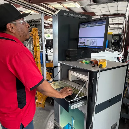 i-Car certified tech at the Car-O-Liner calibration computer terminal