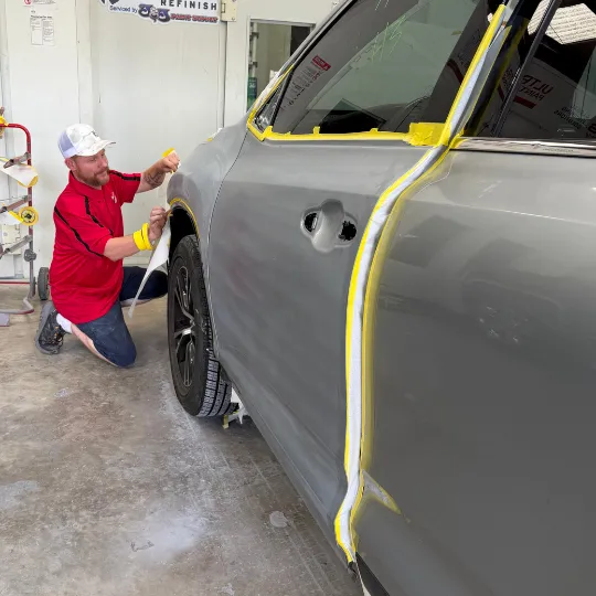 iCar certified technician prepping a car for paint after a collision repair