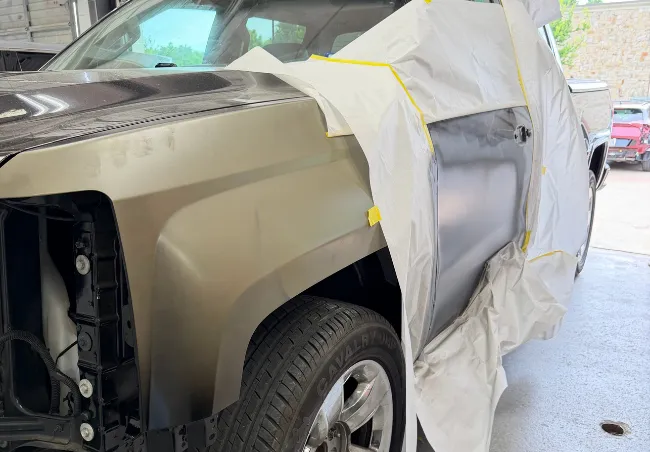 Collision repair prep on a driver side door of a pickup truck