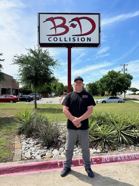 Lance Kruse standing in front of the Mesquite location sign