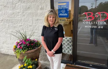 Donna Fuentes standing in front of the entry to B&D Collision in Mesquite