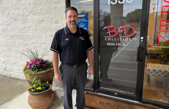 Keith Anglin standing in the front of the entry to B&D Collision in Mesquite