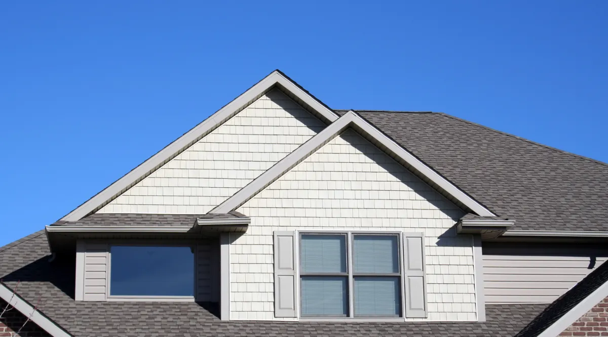 Charming custom suburban home with a spacious front yard, elegant architecture, and a warm, inviting design for comfortable family living.