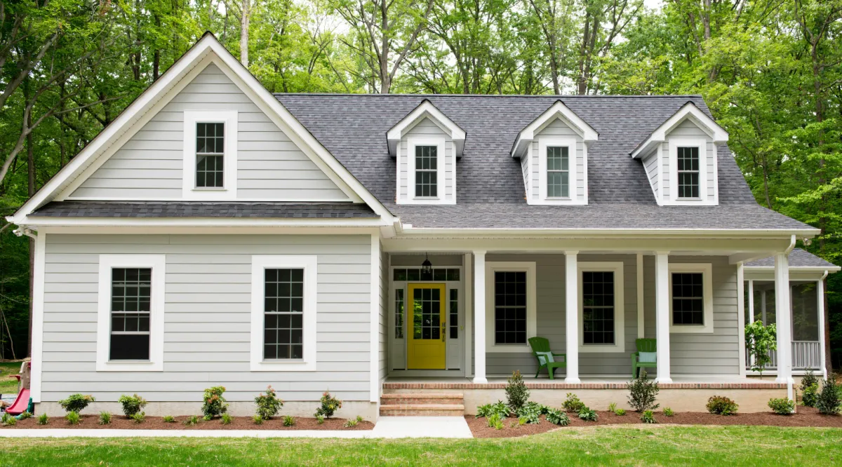 Charming custom suburban home with a spacious front yard, elegant architecture, and a warm, inviting design for comfortable family living.