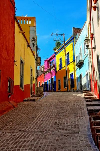 brick-lined narrow street with colorful buildings 