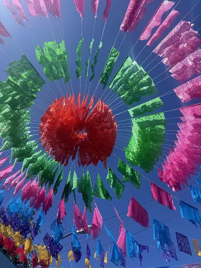Blue Sky with Red, Green, Pink, Blue, and Yellow Papel Picado decoration
