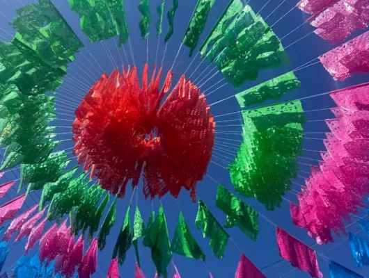 Blue Sky with Red, Green, Pink, Blue, and Yellow Papel Picado decoration