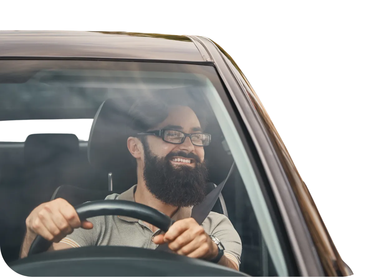 Smiling man behind the wheel of a Budget Ride registered vehicle,