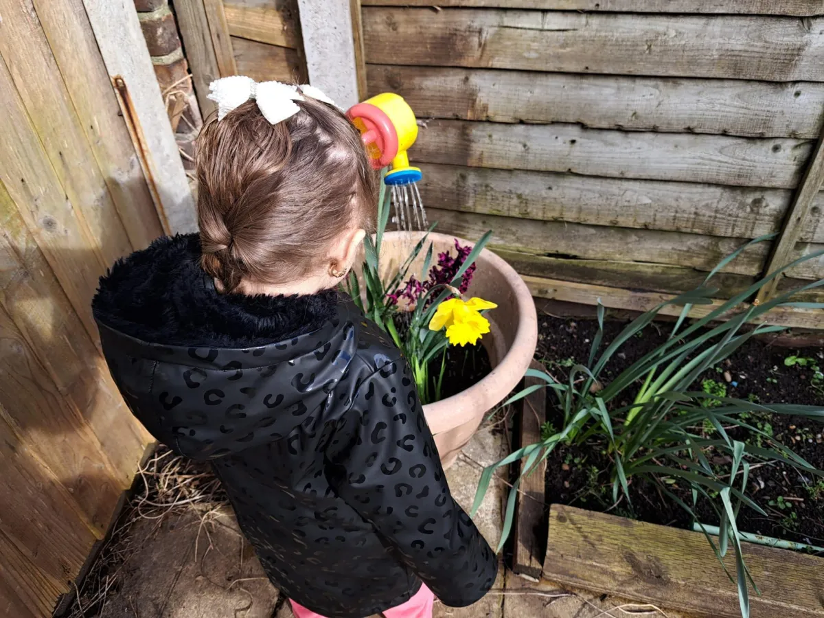 Children planting flowers at Arise & Shine Childcare