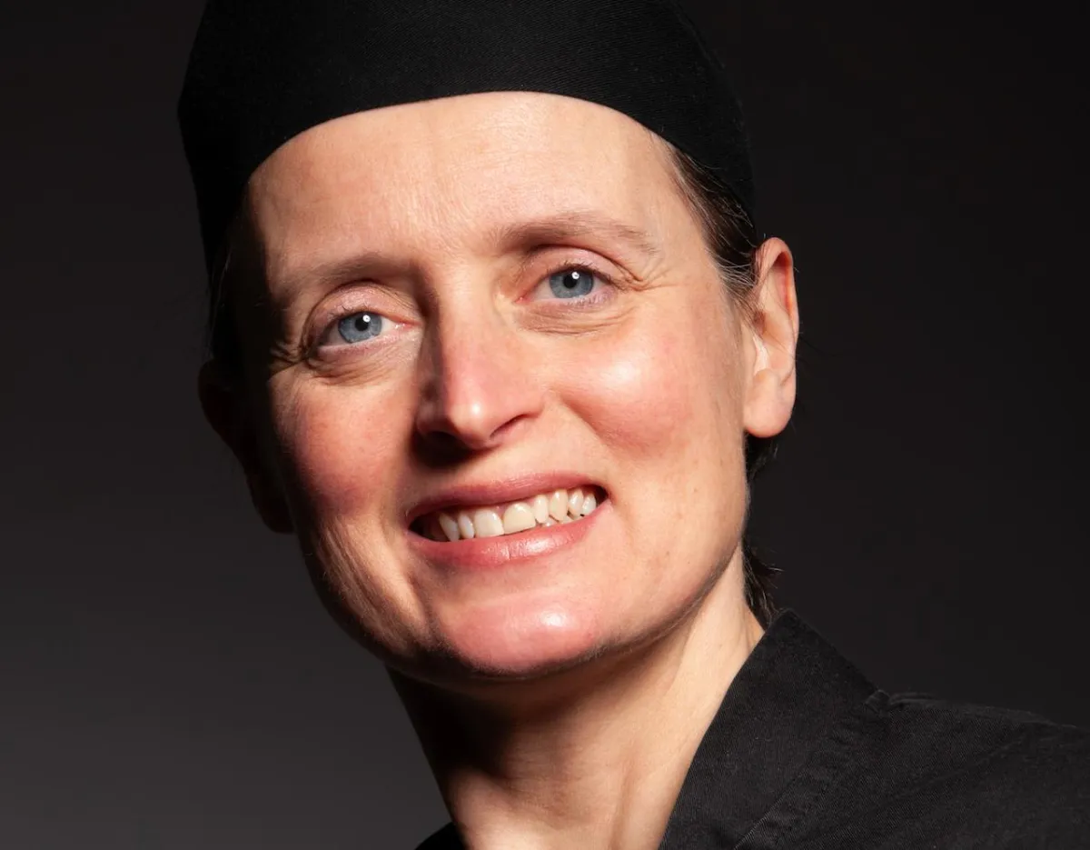 Julia Savory, a professional chef, wearing a chef's hat