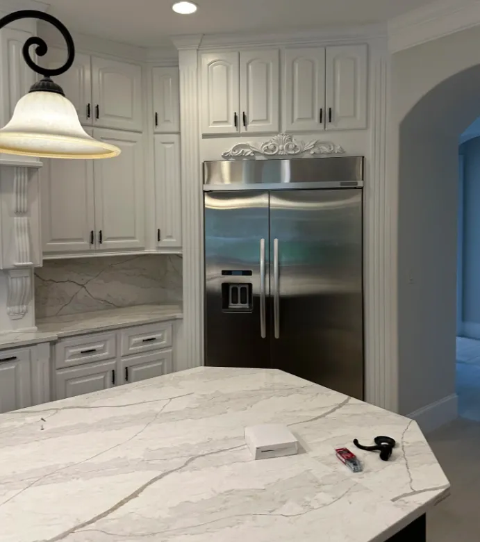 Before and after kitchen cabinet painting transformation in Cypress, TX showing white painted cabinets with modern hardware by Cypress Supreme Painting