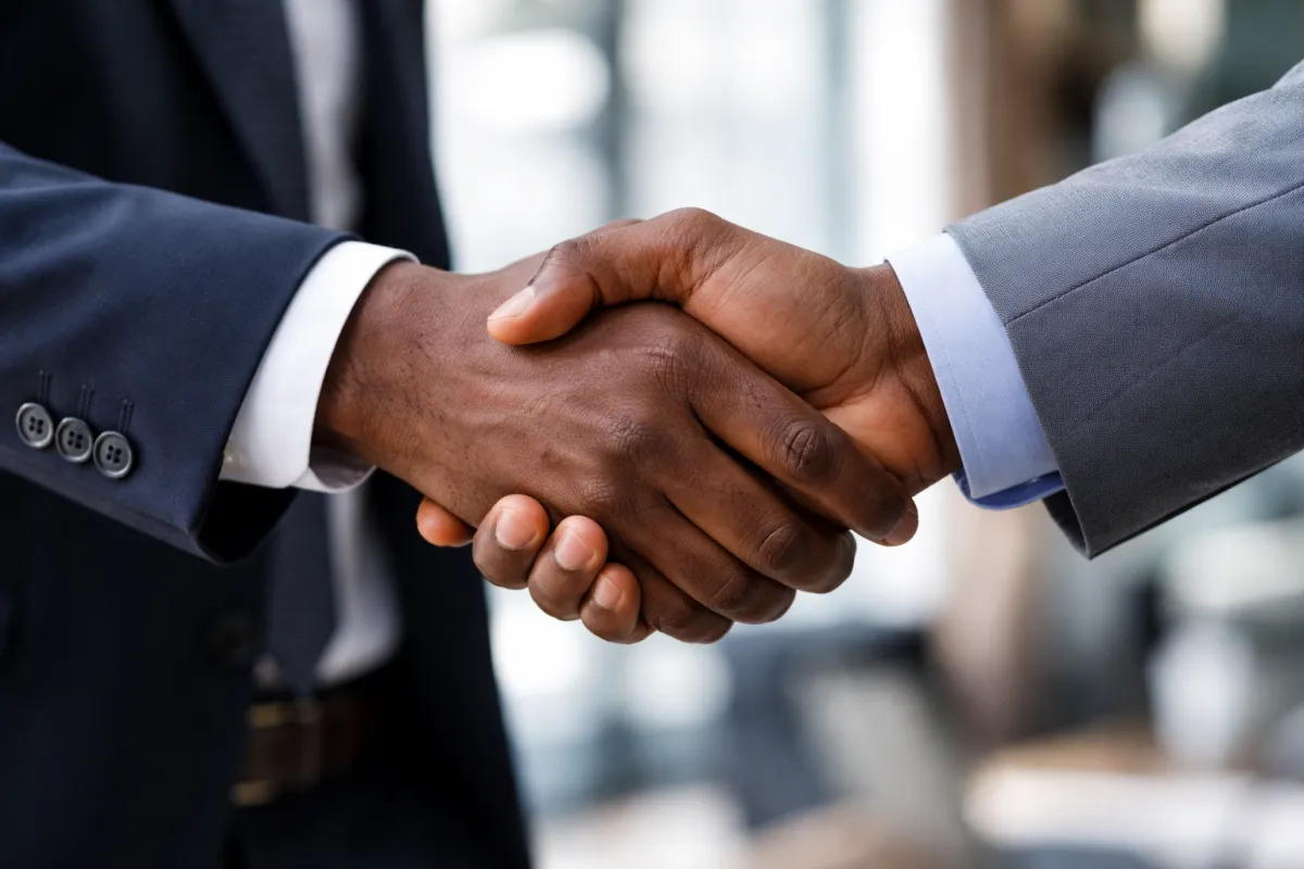 a person holding a child's hand with a yellow background