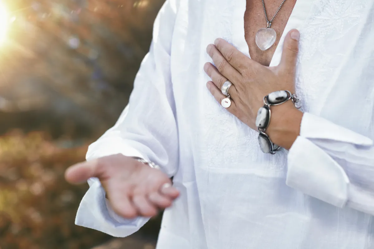 A person meditating on a hilltop during sunrise, symbolizing emotional freedom and clarity.