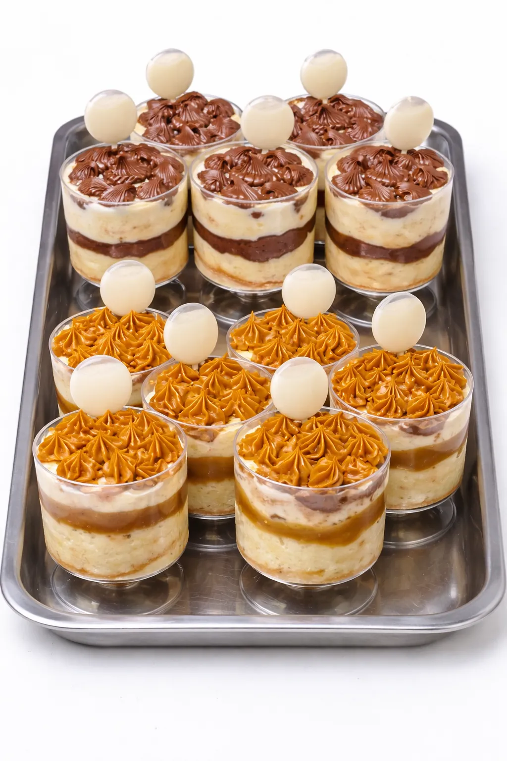 Mini flans and chocoflan arranged on a dessert table