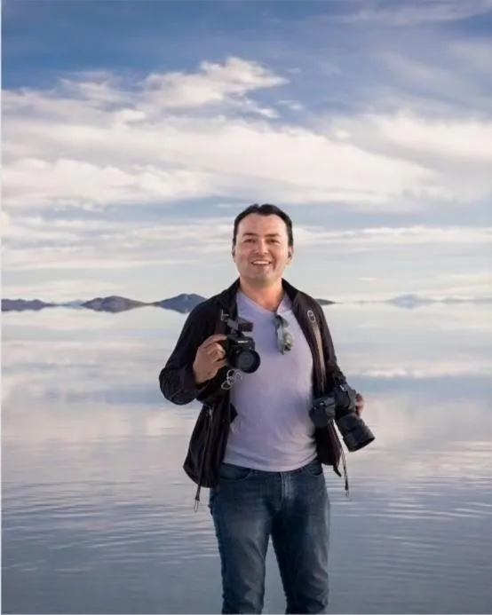 silhouette of 2 person standing on rocky ground during sunset