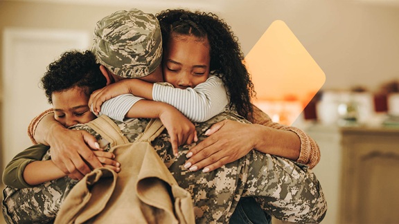 a snow covered tree in a field with trees in the background