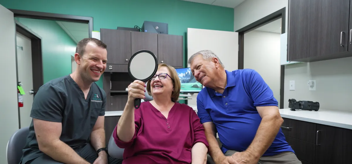 Warm, approachable photo of the dental team helping a happy patient at Dental Arts of Catoosa