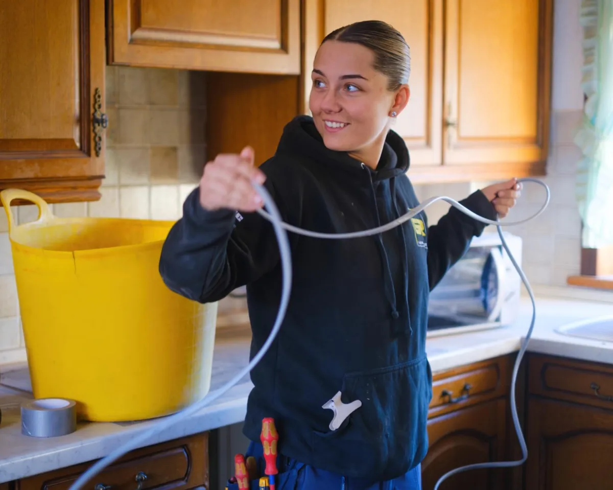Female electrician preparing wiring on-site, Glasgow kitchen project — trade photography.