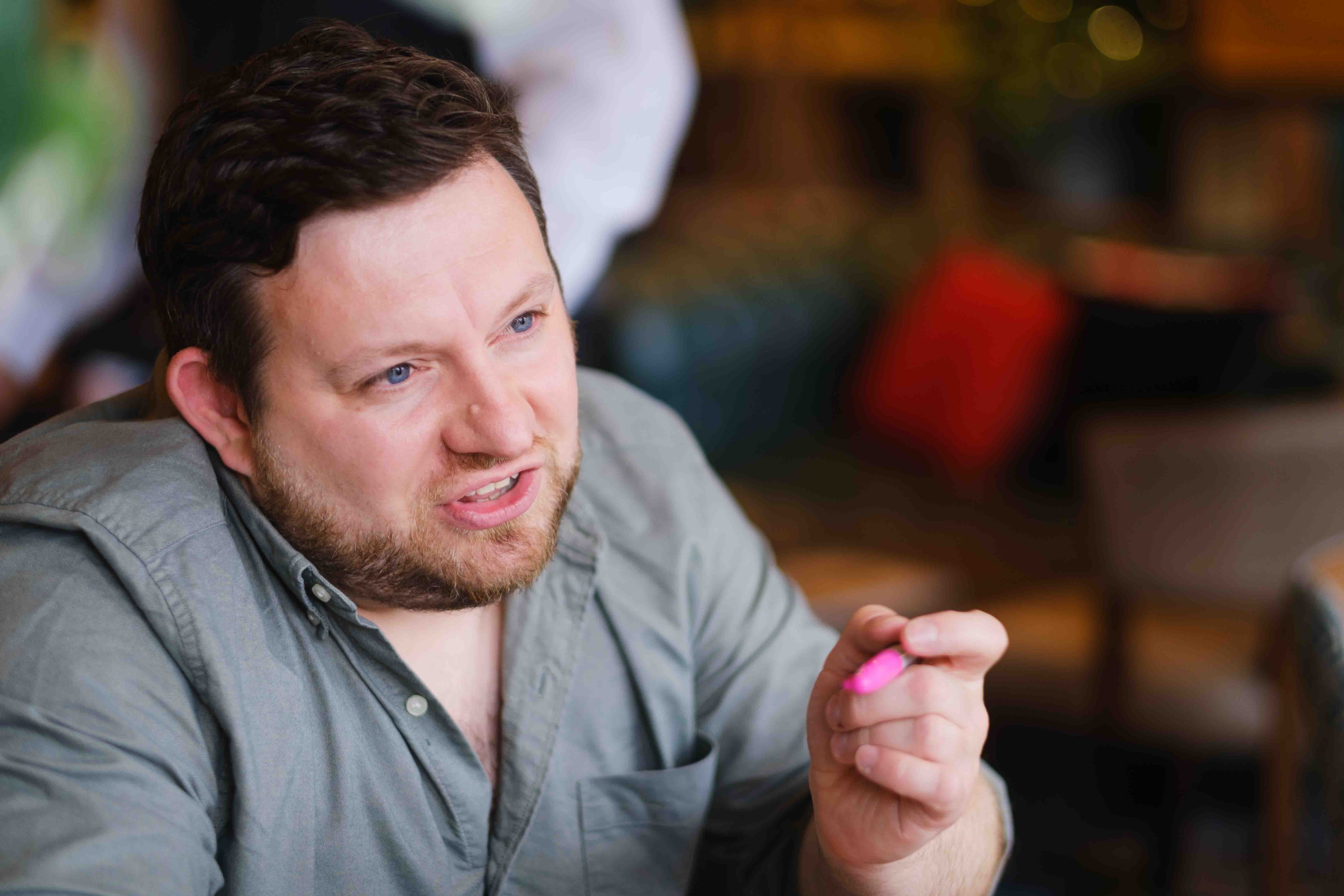 Indoor portrait of male brand and web designer, Ian Fergus, taken in Edinburgh cafe by Victoria Rose Photography