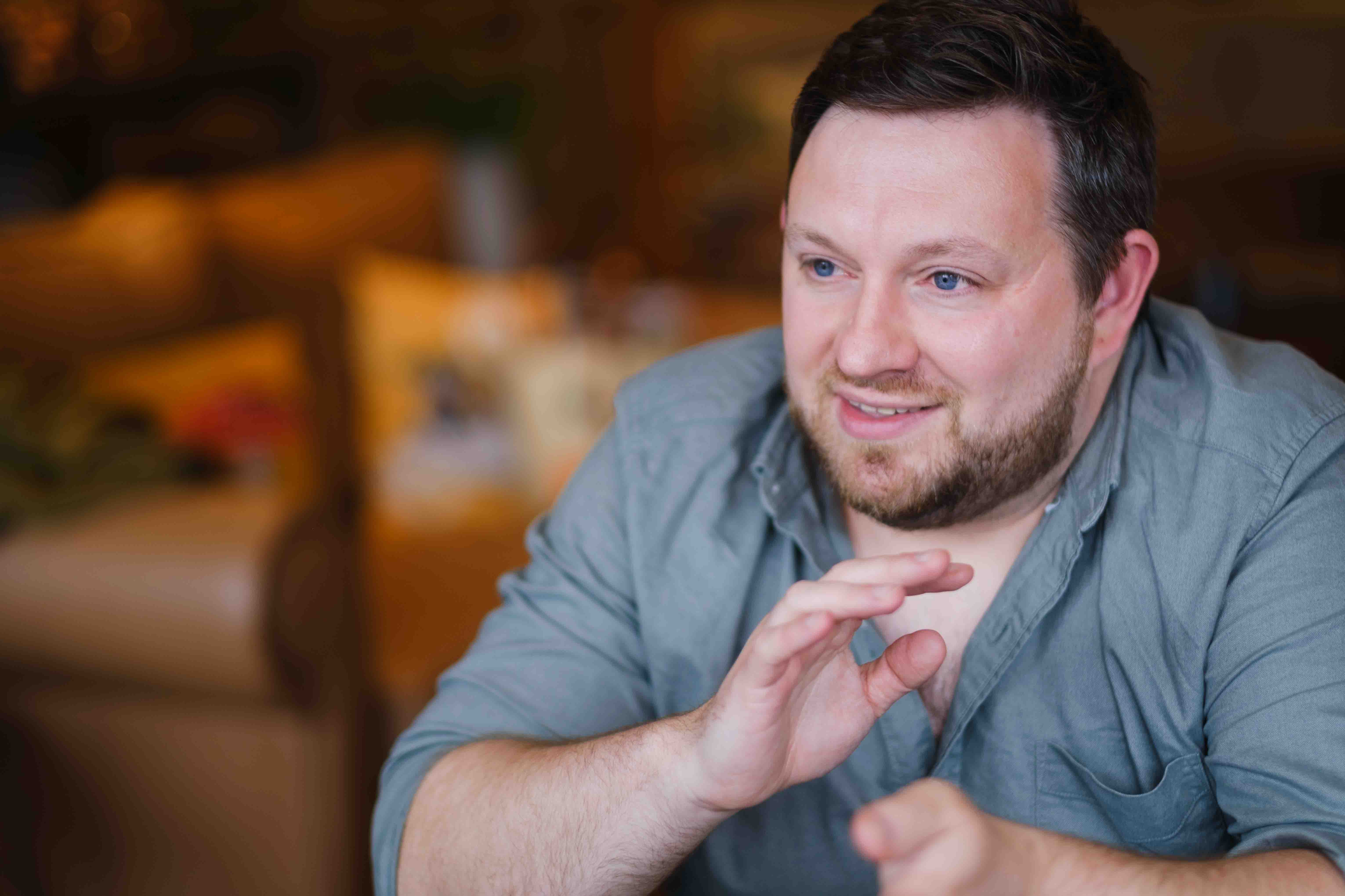 Indoor portrait of male brand and web designer, Ian Fergus, taken in Edinburgh cafe by Victoria Rose Photography