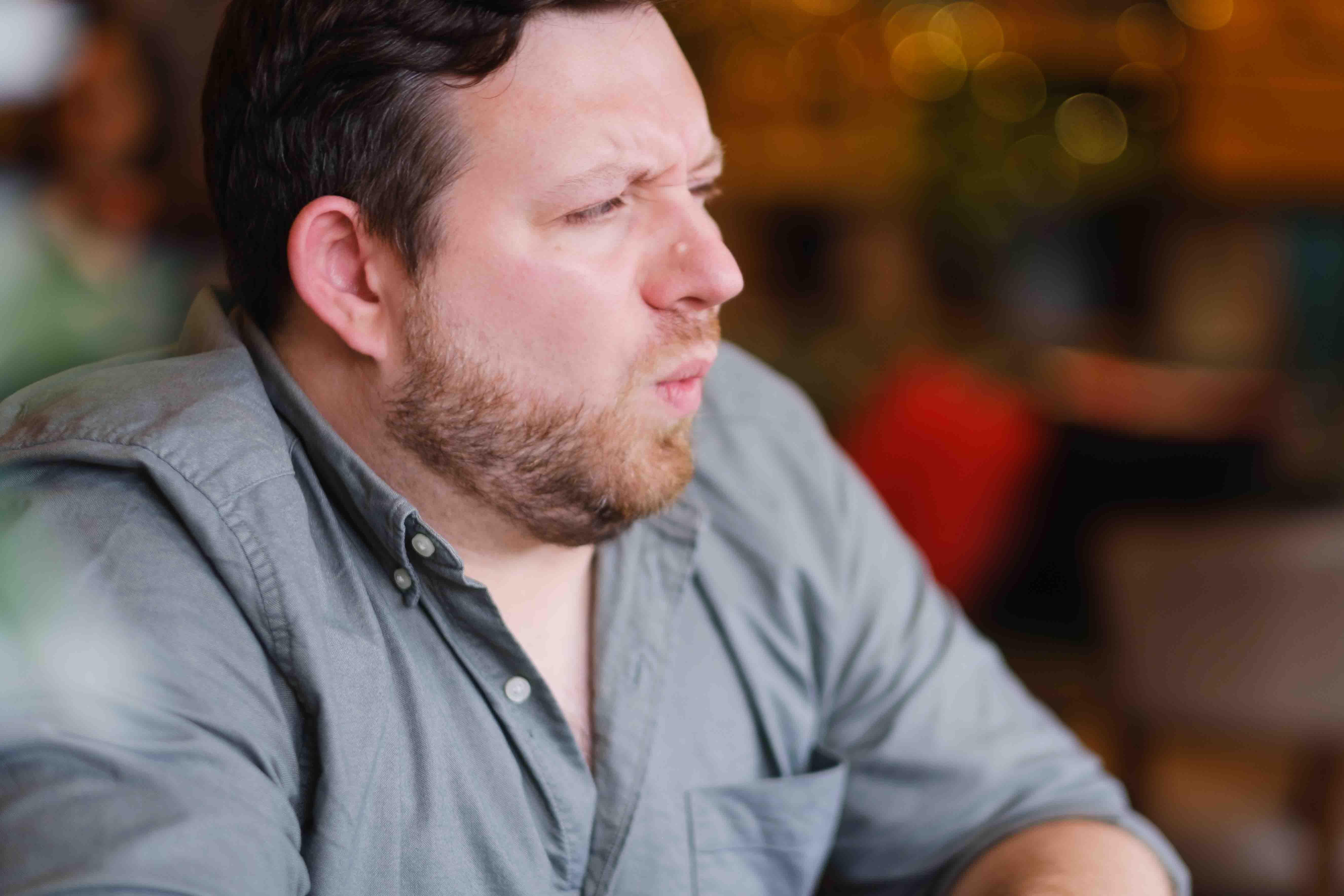 Indoor portrait of male brand and web designer, Ian Fergus, taken in Edinburgh cafe by Victoria Rose Photography