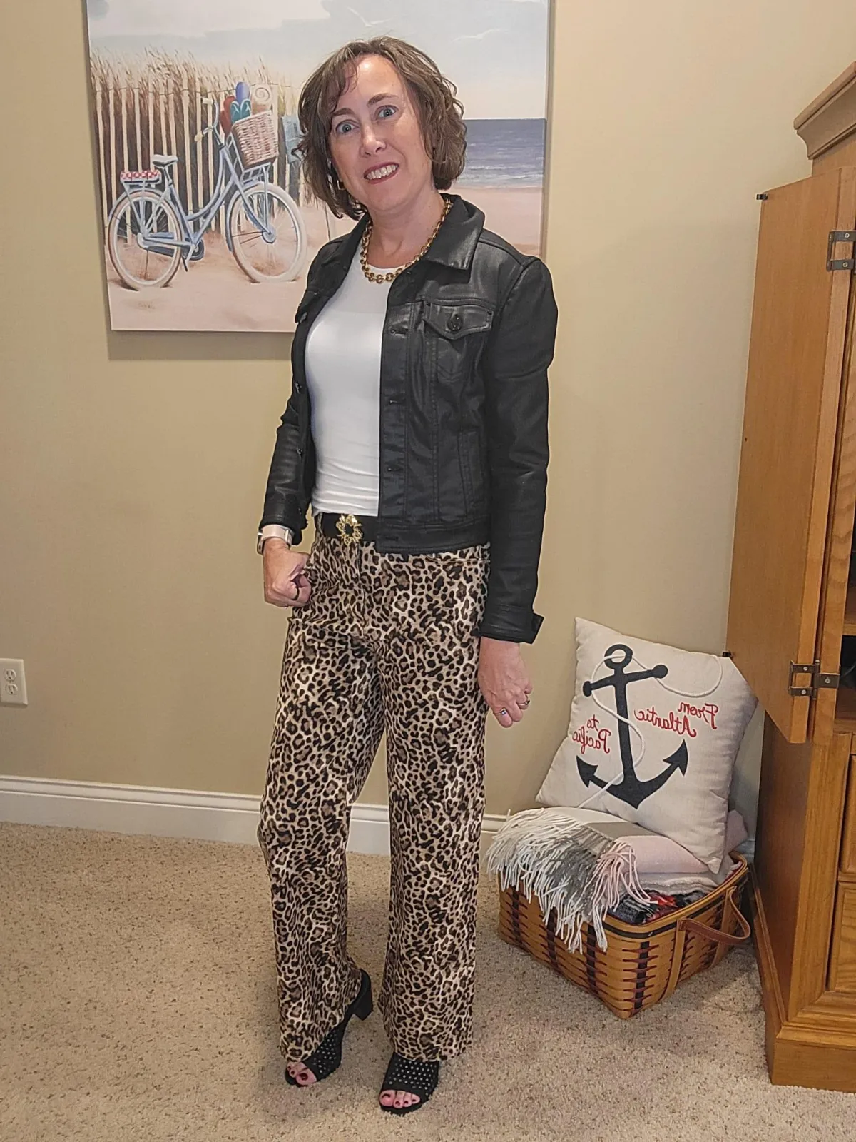 Jenn Whitacre wearing a black coated denim jacket over a white long-sleeve Loft tee with Loft leopard print jeans, gold necklace, earrings, black belt, and black heeled sandals — stylish fall outfit inspiration by Styled by Jenn.