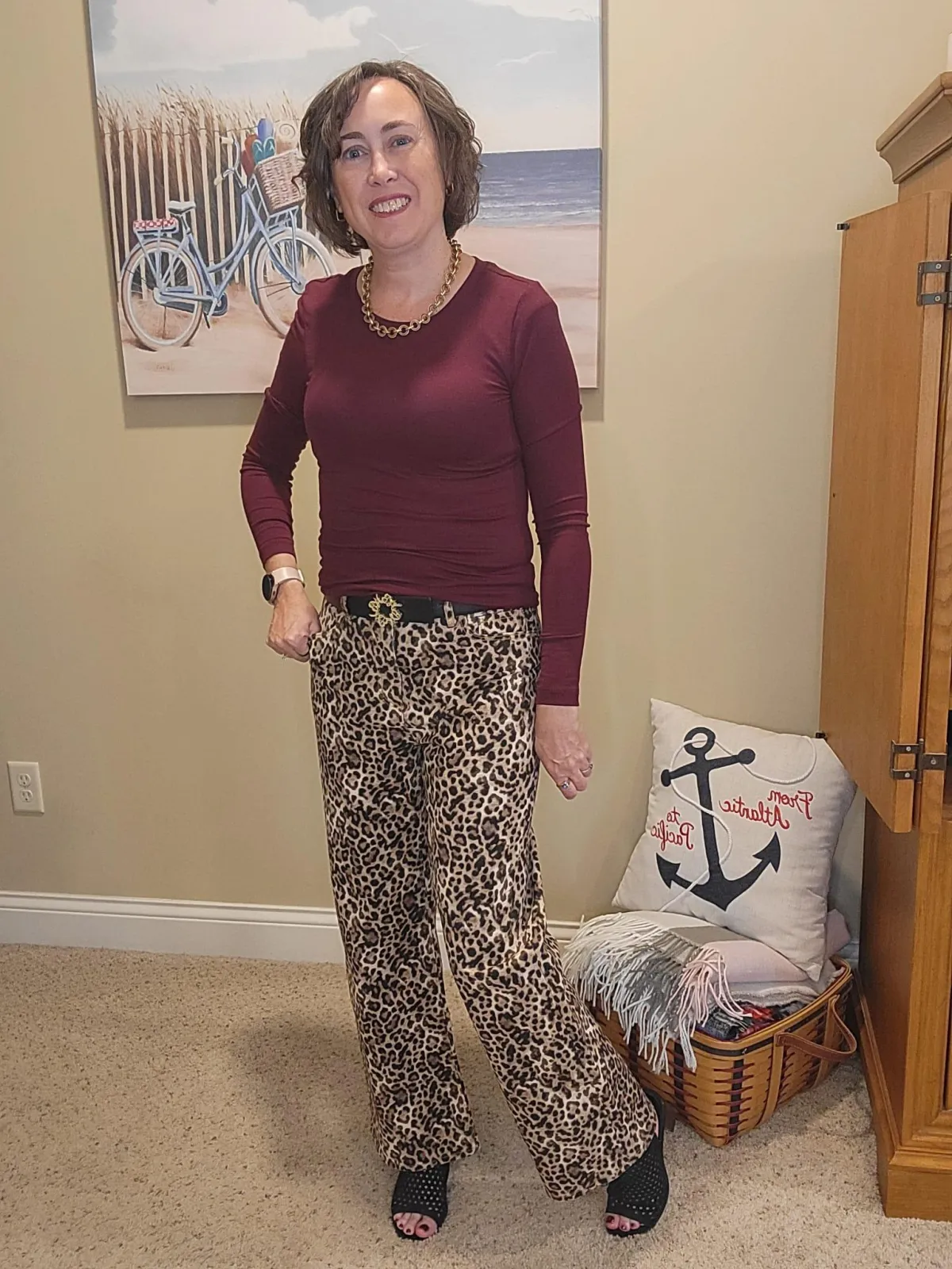 Jenn Whitacre wearing Loft leopard print jeans with a burgundy long-sleeve tee, gold necklace, black belt, and black heeled sandals — chic fall outfit inspiration by Styled by Jenn.