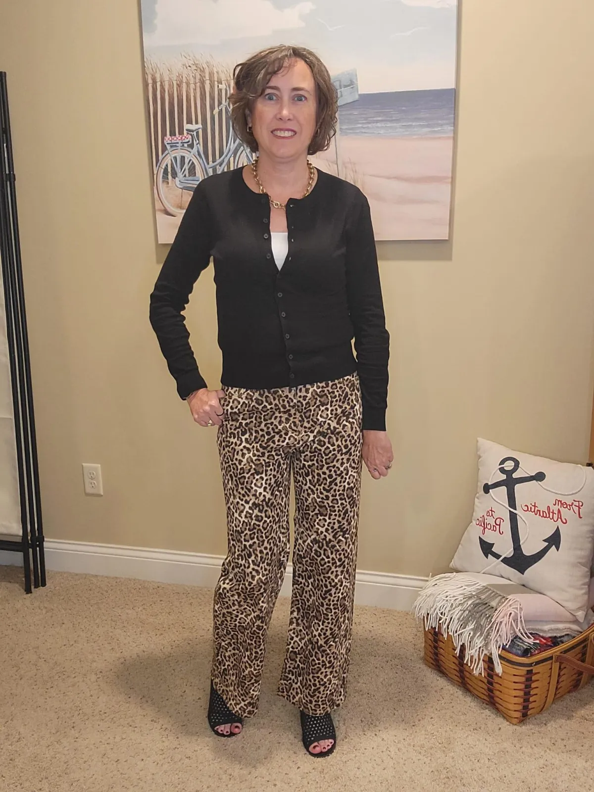 Jenn Whitacre wearing leopard print pants and a black cardigan before altering the fit, showing a looser silhouette.