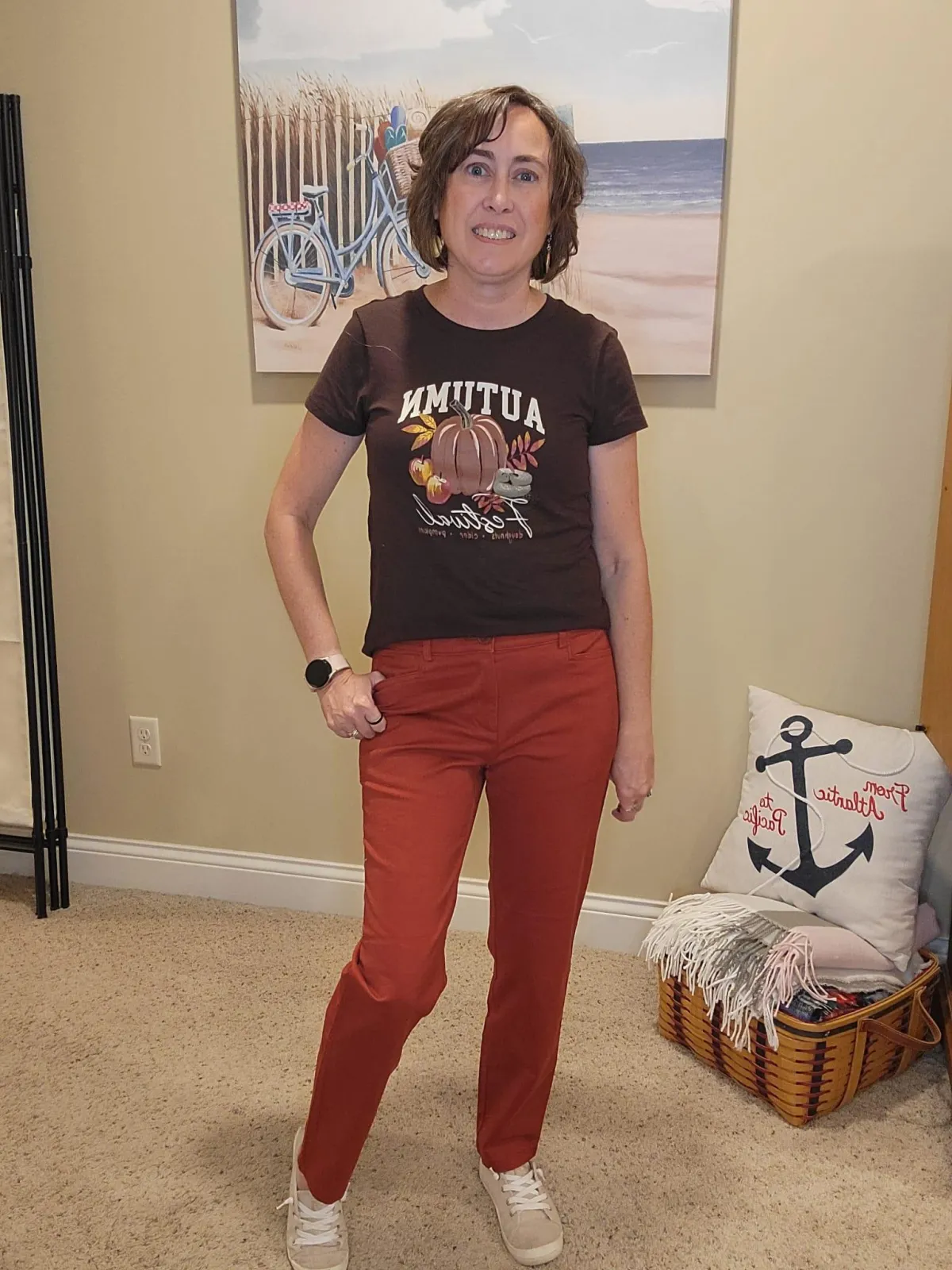 Jenn Whitacre wearing a Loft Outlet brown fall graphic tee with rusty pumpkin pants and beige sneakers — cozy fall outfit inspiration by Styled by Jenn.