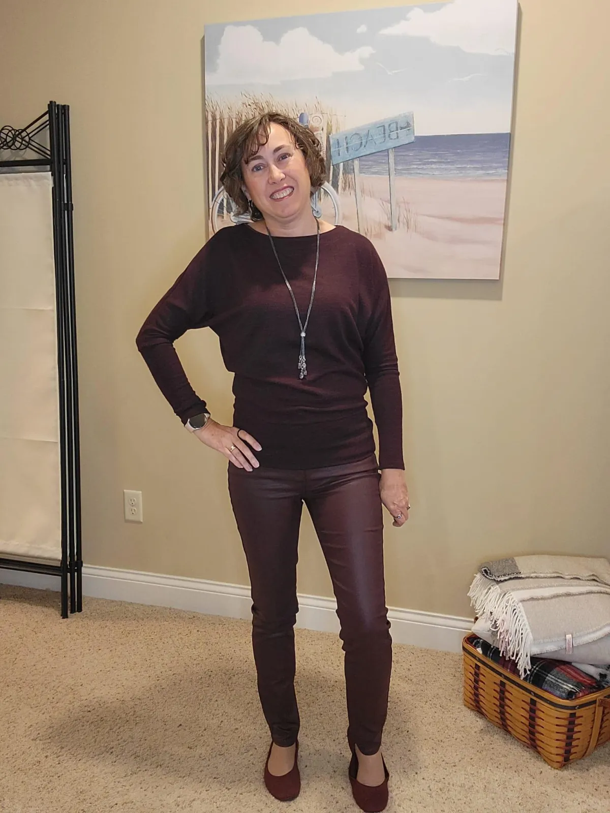 Jenn Whitacre wearing a WHBM burgundy top with matching coated denim jeans, silver long necklace and earrings, and burgundy Croft & Barrow flats — a polished monochrome fall outfit.
