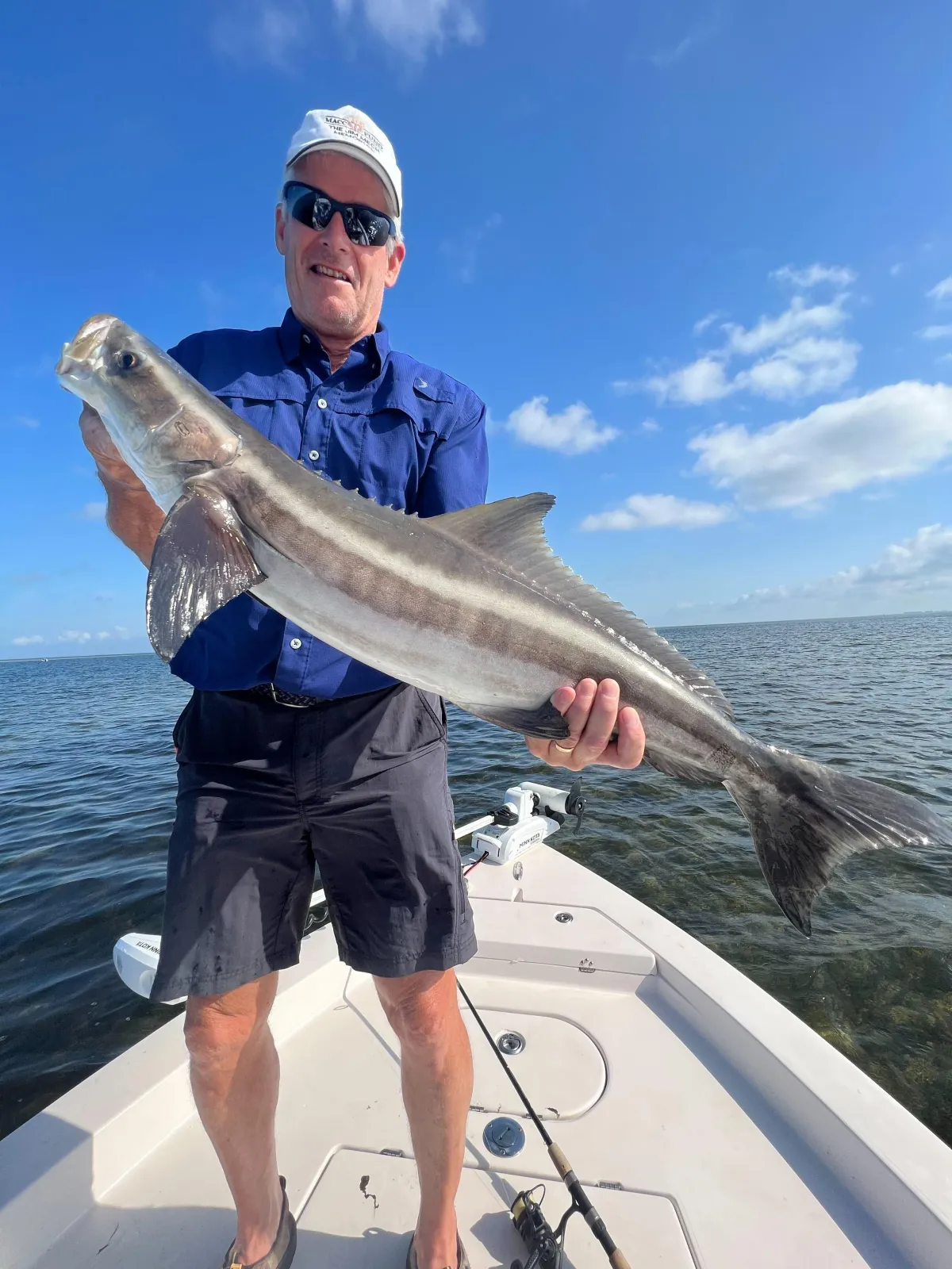 “Angler showing off a large redfish caught during an offshore fishing charter with Captain Tanner near Gulf Shores, Alabama.”
