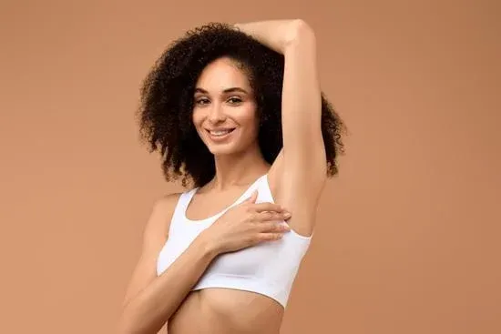 a pink flower sitting in the middle of a lush green field