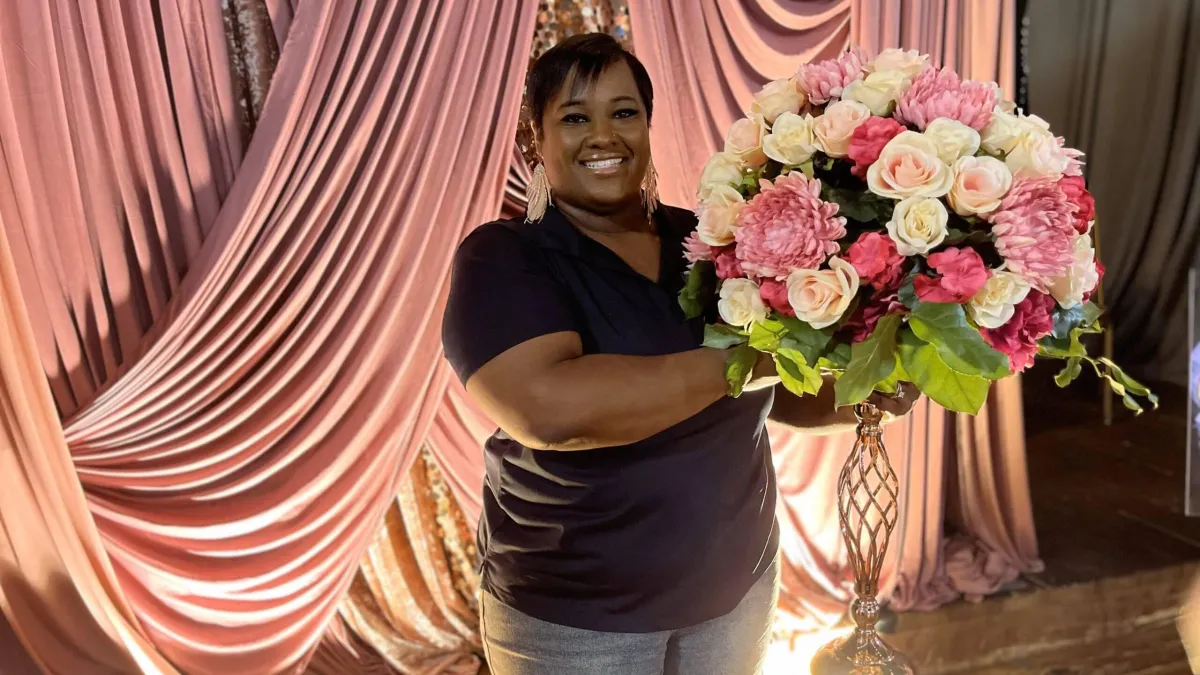 Elegant floral centerpiece and custom backdrop with metallic rose gold accents styled in Nacogdoches