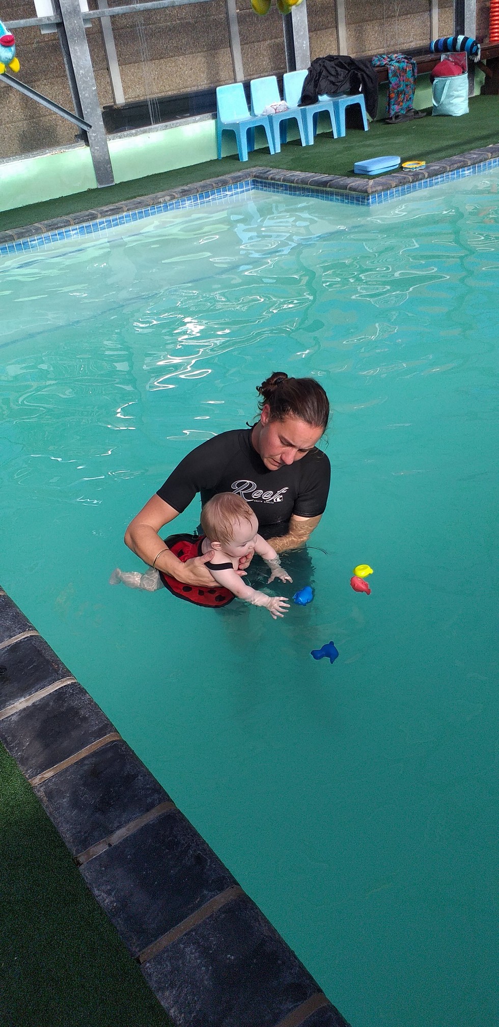 Sonja supporting a student in a calm aquatic teaching session