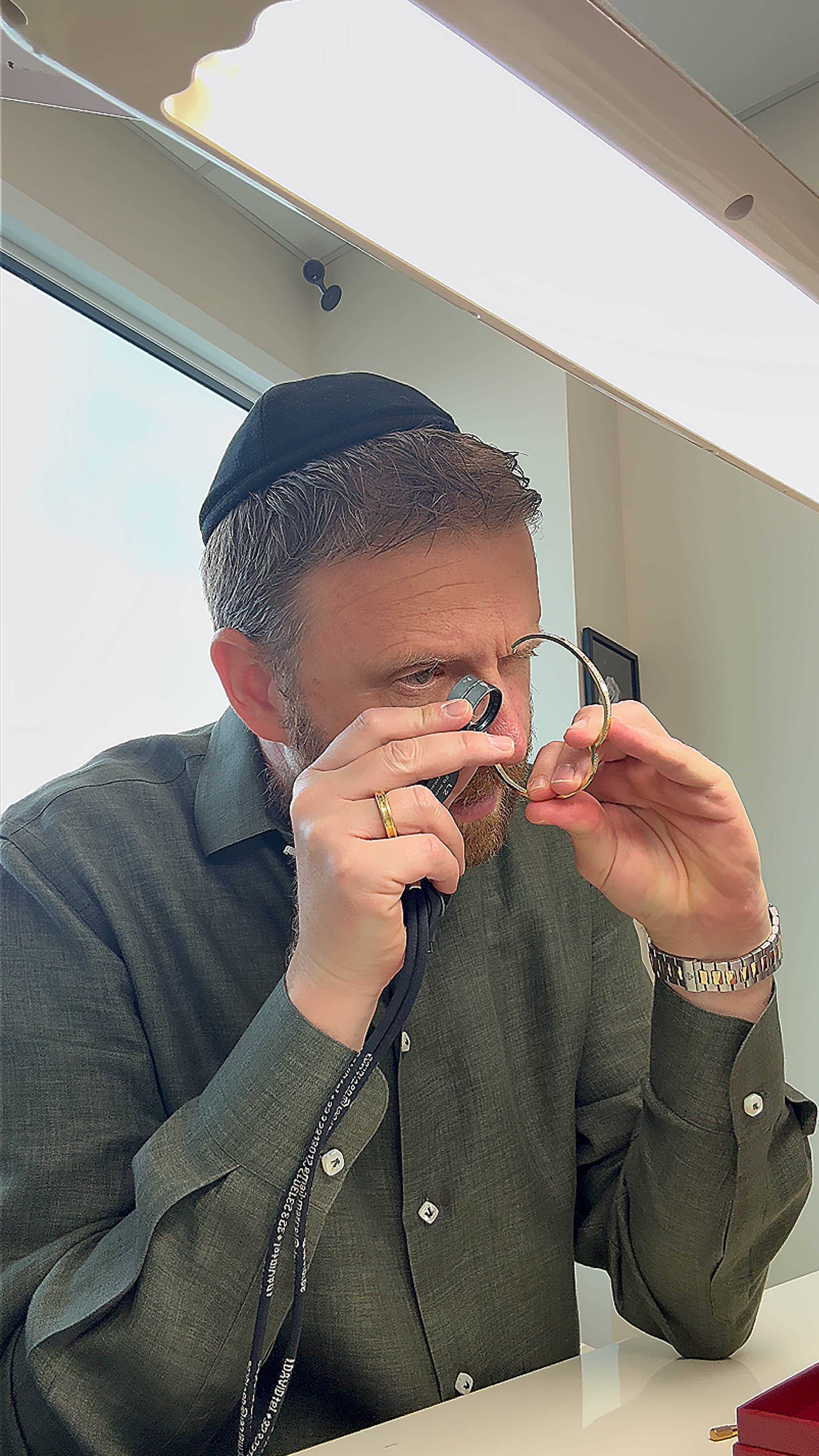 Specialist's gloved hands examining an exceptional estate diamond