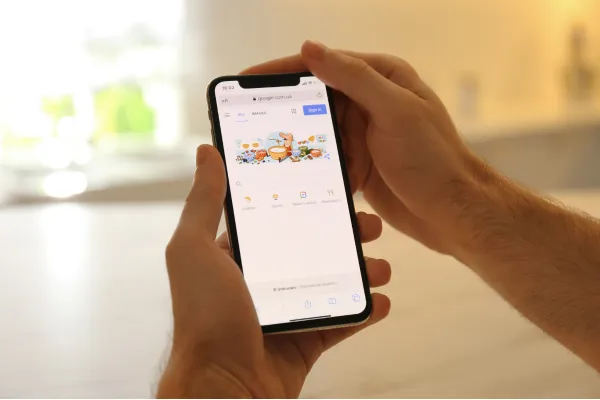 Person opening the Google search page on their mobile phone to look up a local Blue Mountains business