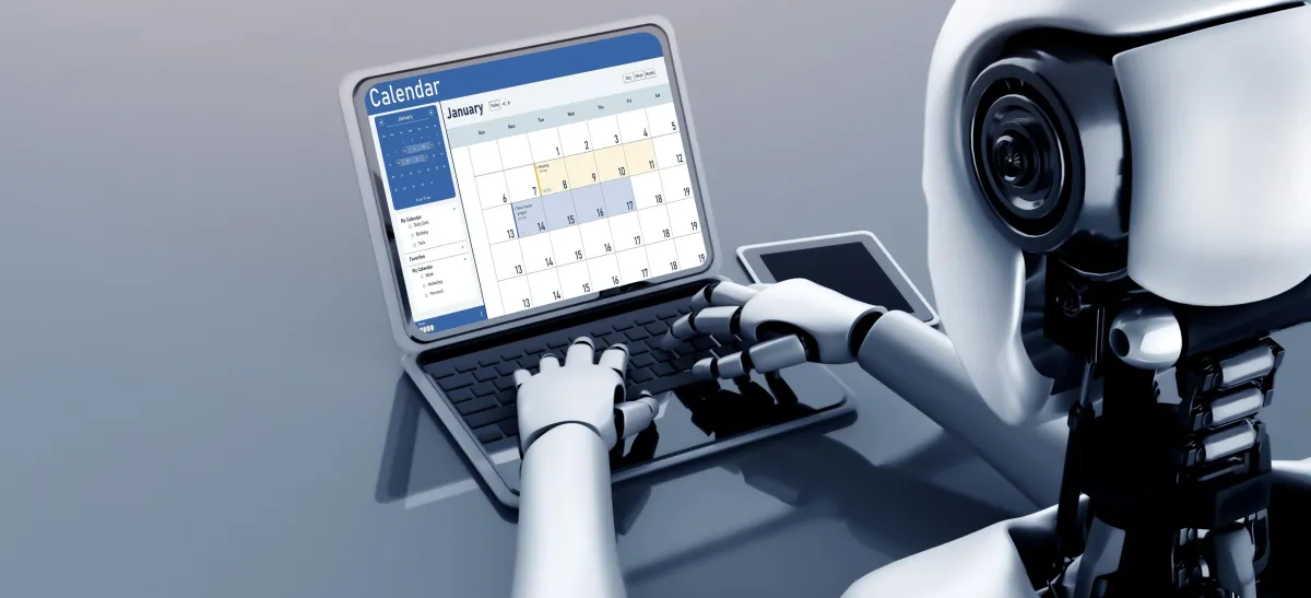 Picture of robot typing on laptop to schedule an appointment