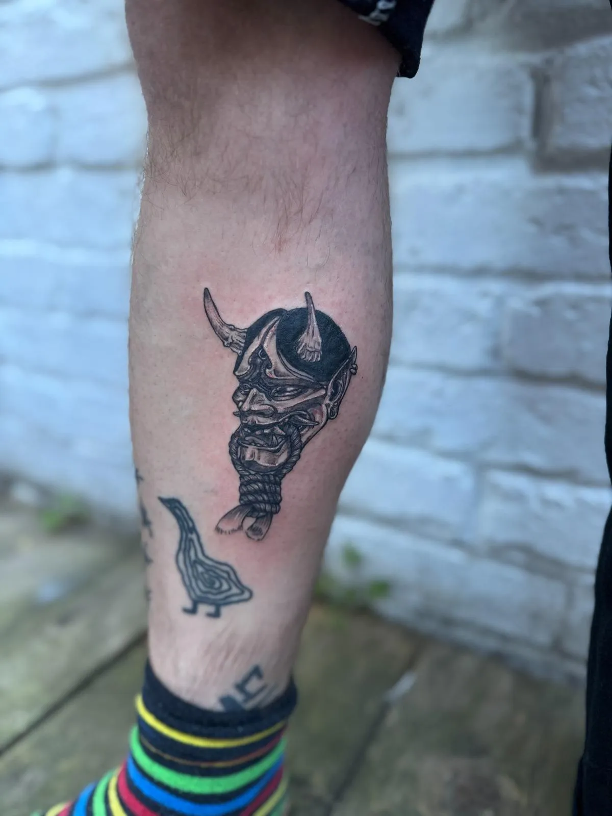 person in blue denim shorts and white nike sneakers standing on gray concrete floor