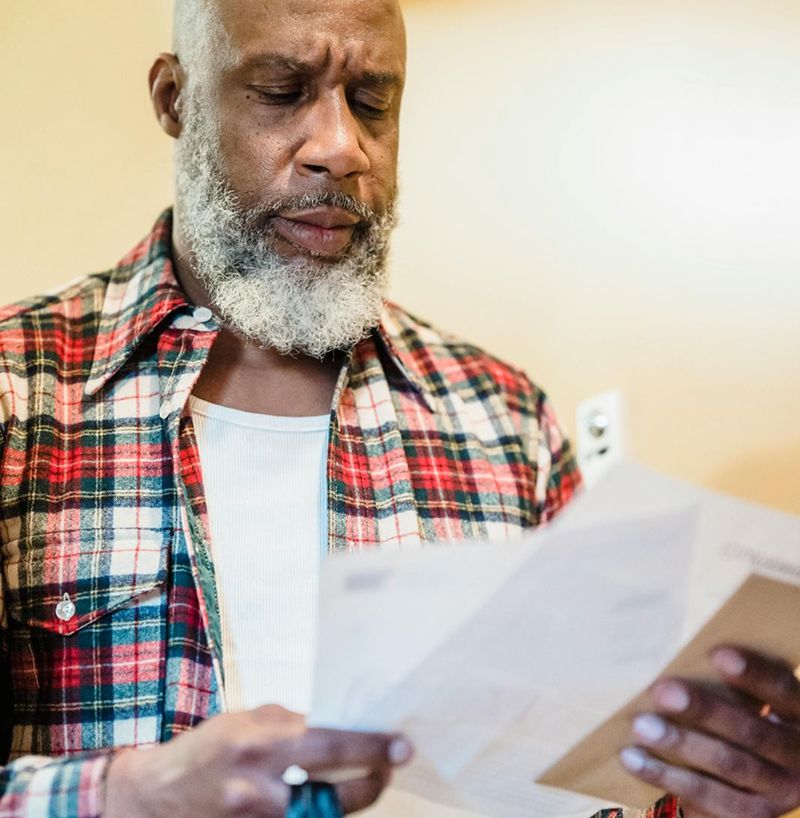 A man looking disappointed at his block insurance policy