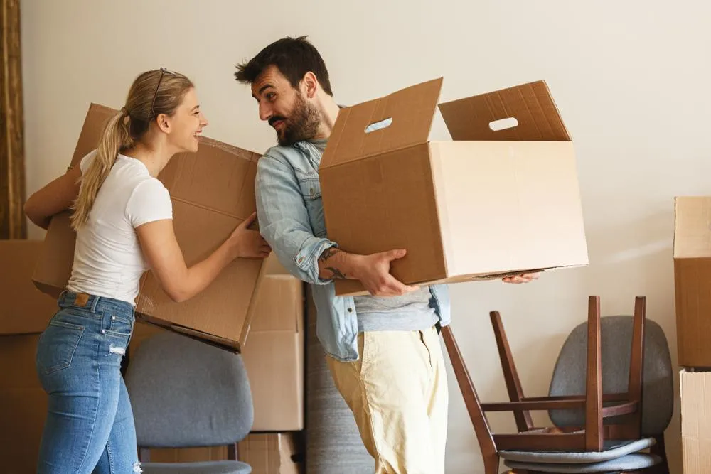 image of couple unloading boxes after a move into a new home
