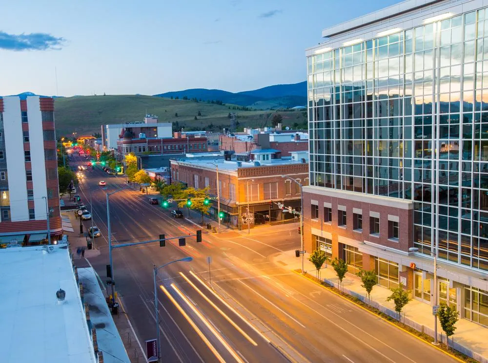 image of downtown missoula at sunrise with traffic blurred