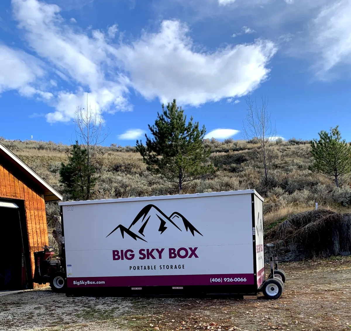 image of a big sky box portable storage in Kalispell container in front of a barn