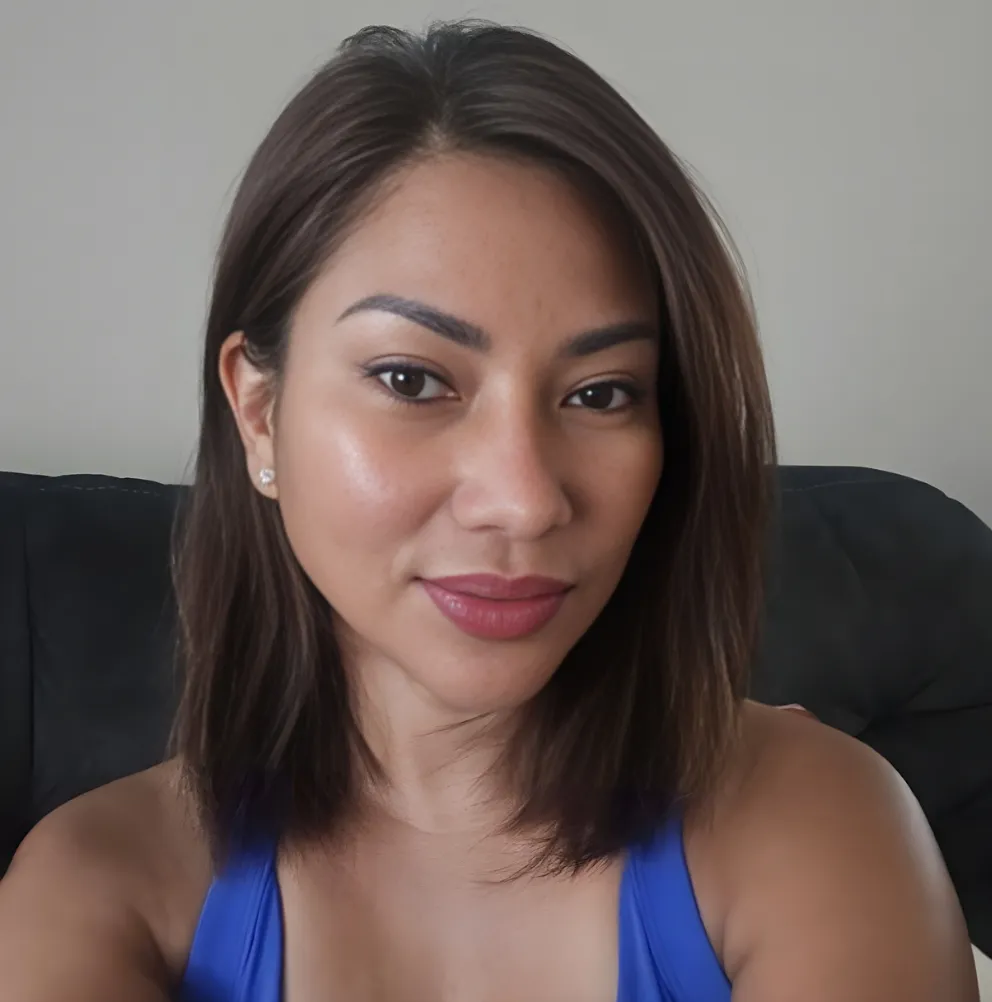 Neslyn journaling at a cozy Parisian café, a steaming cup of coffee beside her. The street outside is bustling, but she is focused and content, immersed in her thoughts. 1:1 aspect ratio.